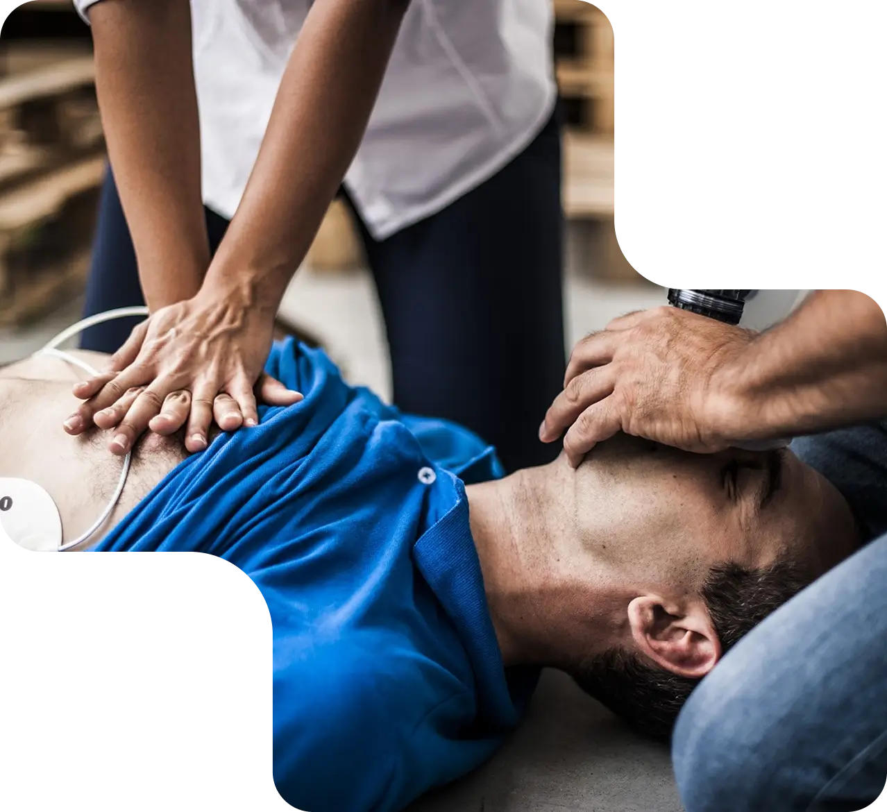 Real-life CPR being performed on man outdoors during emergency.